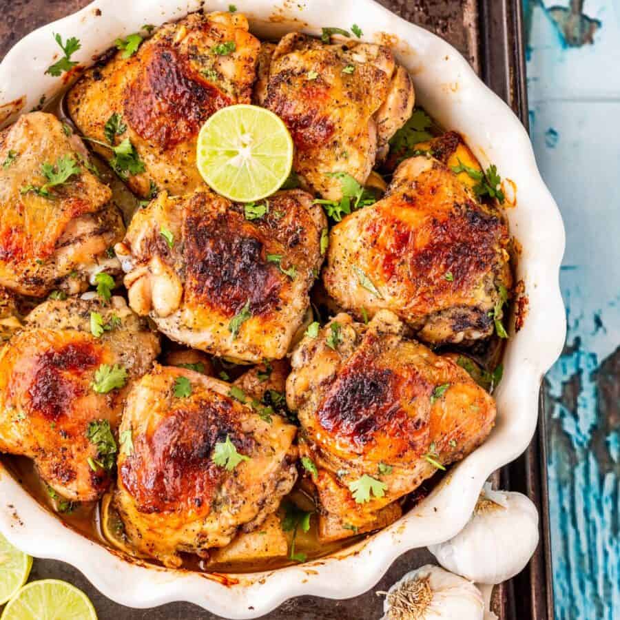 Overhead image of Baked Honey Lime Chicken thighs in a white baking dish