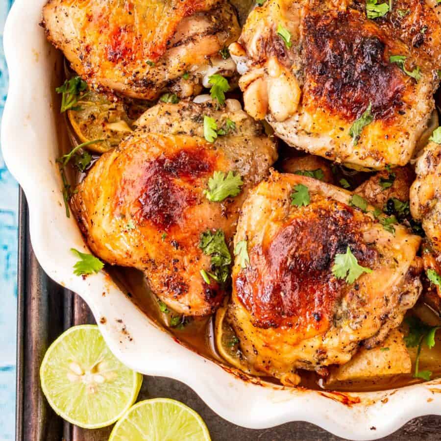 Close up image of Honey Lime Chicken thighs in a white baking dish