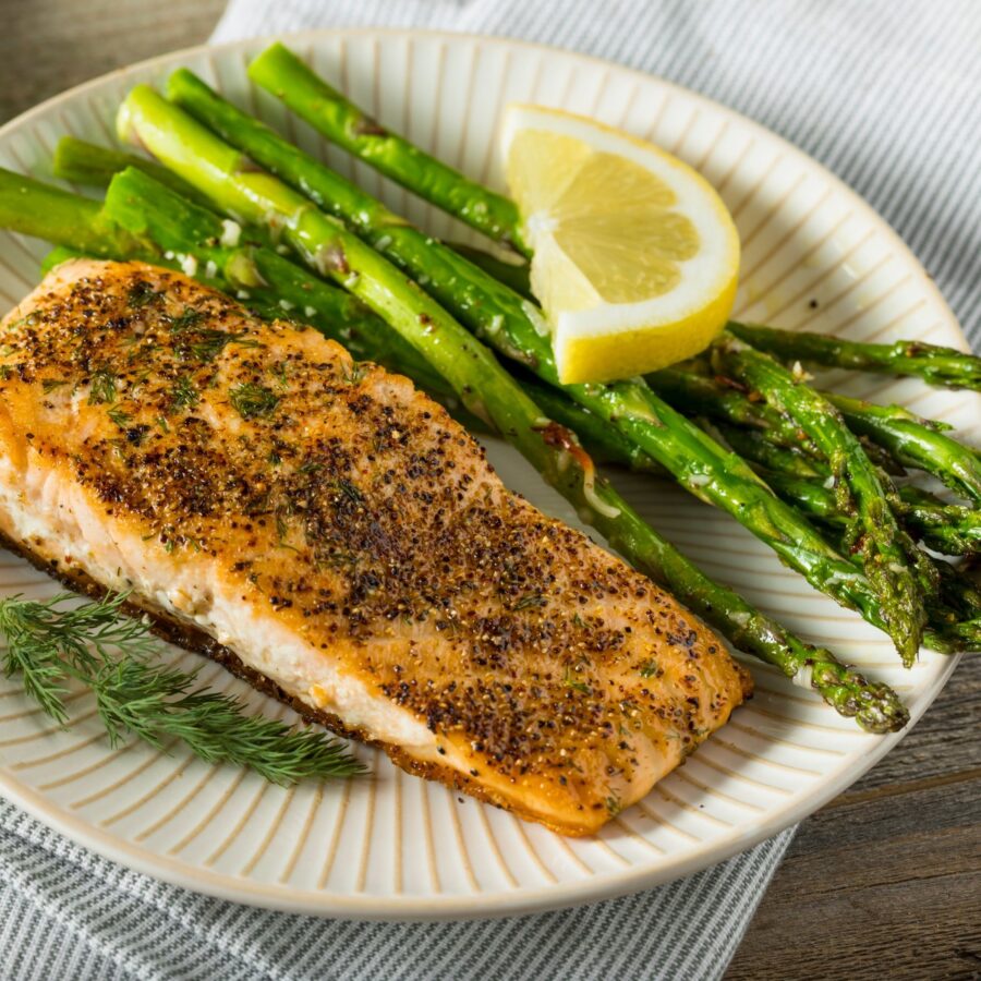 Pan Seared Salmon on a white plate with asparagus