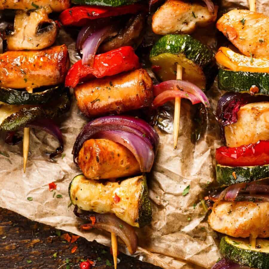 Close up image of grilled pork kabobs on parchment paper