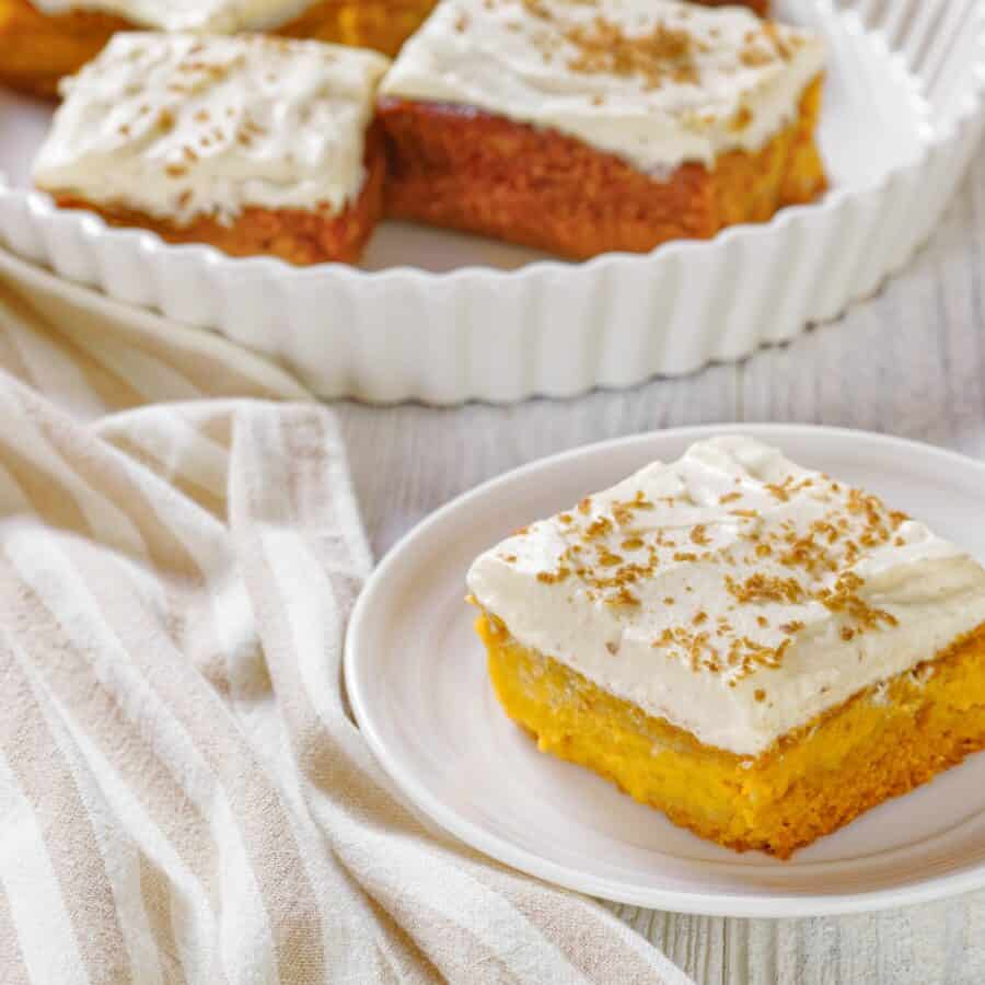 Pumpkin Bars with Cream Cheese Frosting on white dishes