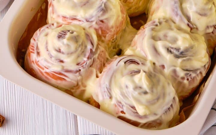 Close up image of Pumpkin Cinnamon Rolls with cream cheese frosting