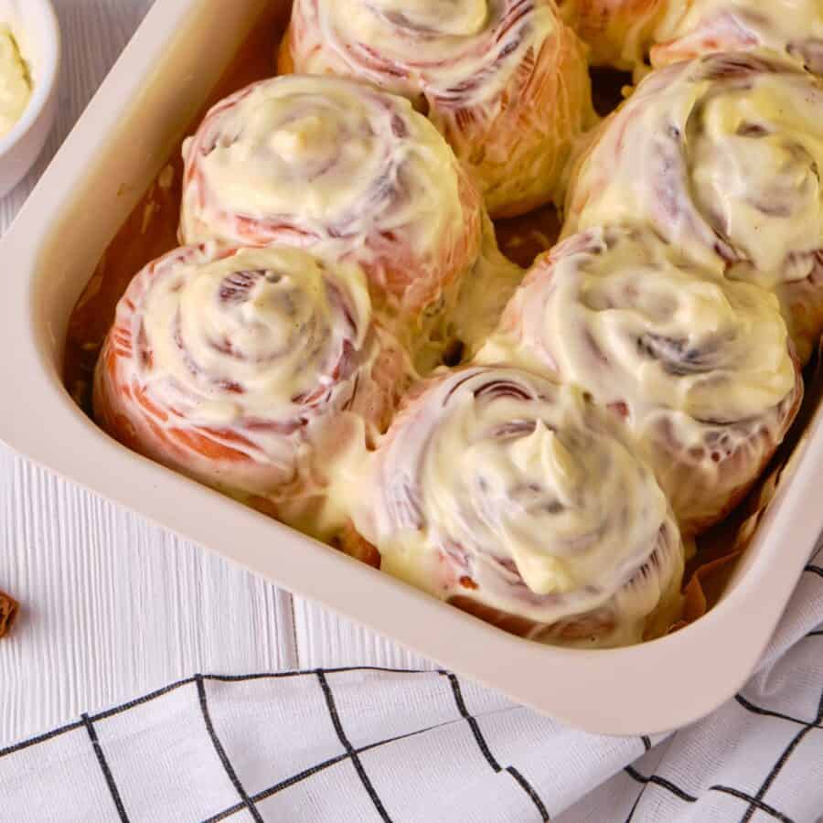 Close up image of Pumpkin Cinnamon Rolls with cream cheese frosting