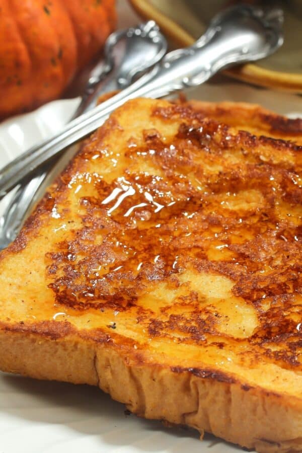 Pumpkin French Toast on a white plate with cutlery