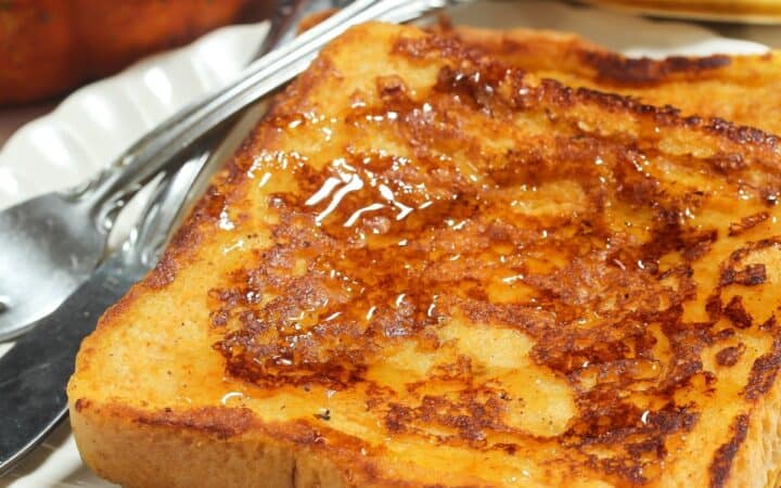 Pumpkin French Toast on a white plate with cutlery