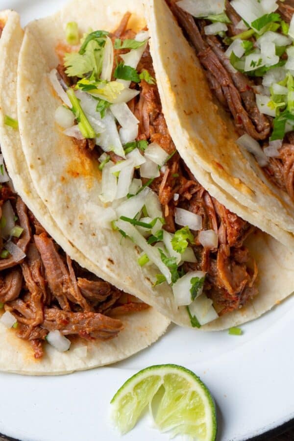 Slow Cooker Barbacoa on three tortillas