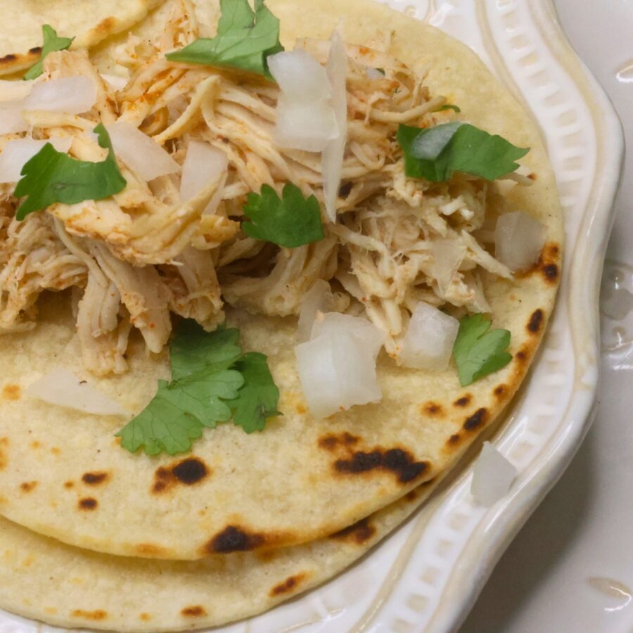 Close up image of slow cooker street tacos on a white plate