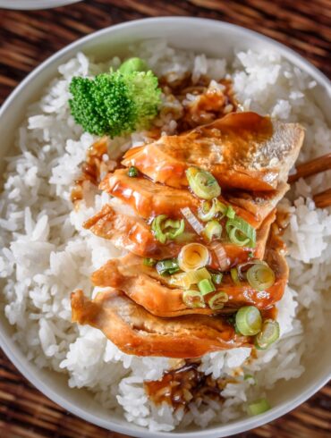 Overhead image of Slow Cooker Chicken Teriyaki in a white bowl with cooked rice