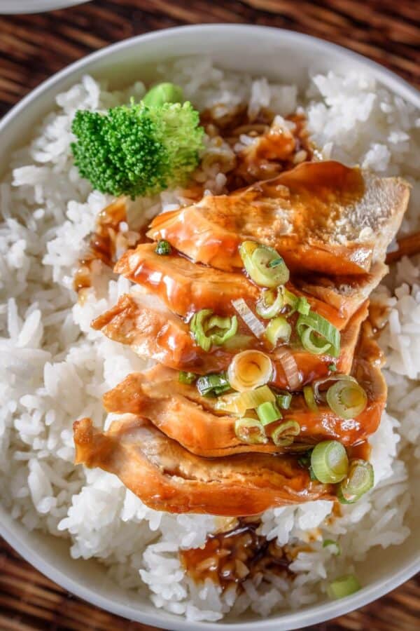 Overhead image of Slow Cooker Chicken Teriyaki in a white bowl with cooked rice