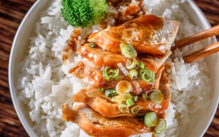 Overhead image of Slow Cooker Chicken Teriyaki in a white bowl with cooked rice