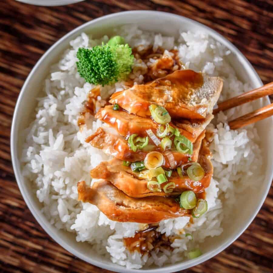 Overhead image of Slow Cooker Chicken Teriyaki in a white bowl with cooked rice