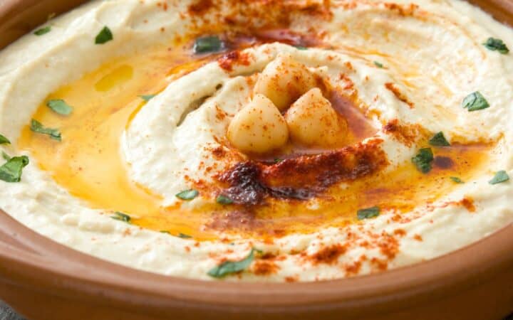 Close up image of Spicy Hummus in a brown bowl