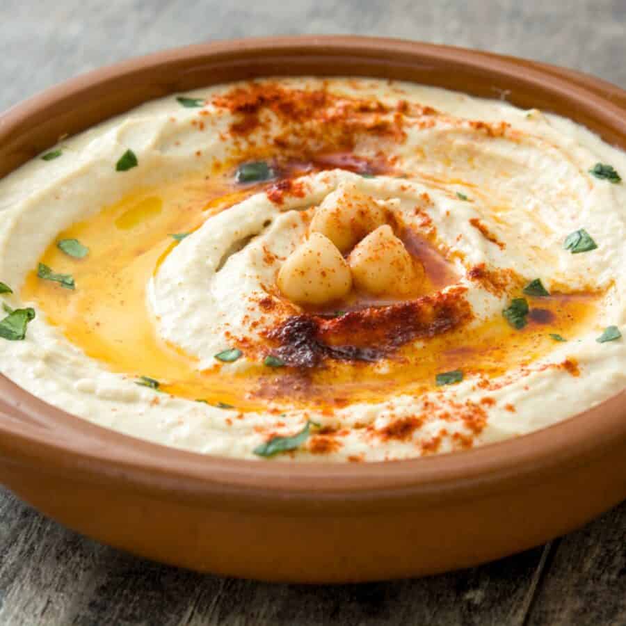 Close up image of Spicy Hummus in a brown bowl