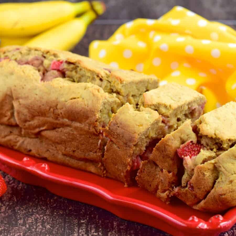 Close up image of Strawberry Banana Bread on a red serving tray