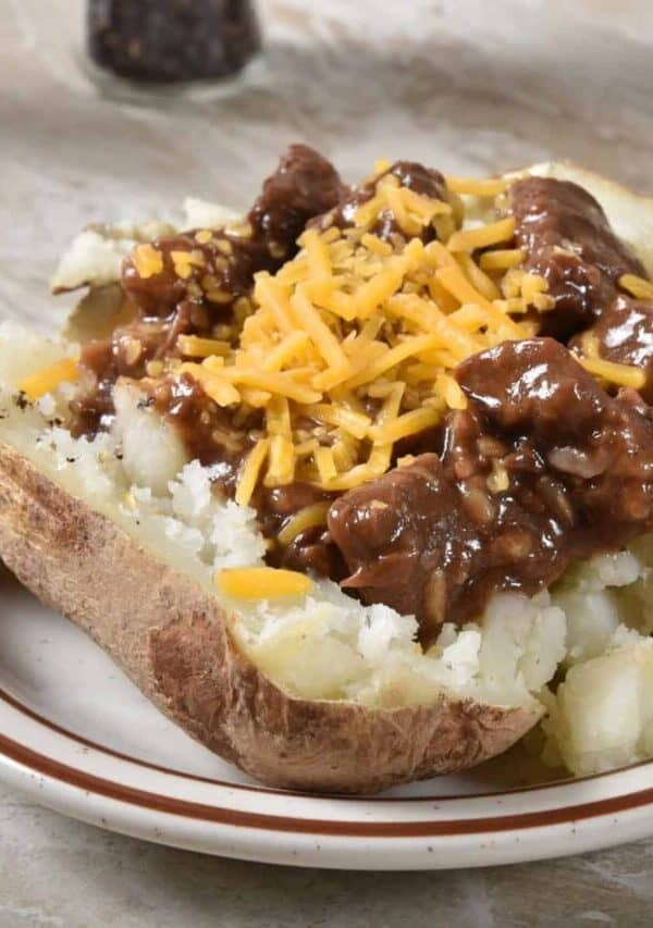 Beef Tips in Gravy on top of a baked potato