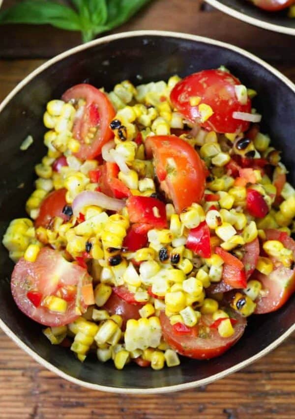 Overhead image of Corn and Tomato Salad in a black bowl