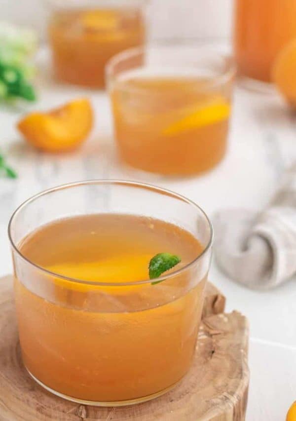 Glasses of Peach Lemonade on a decorative wooden plank