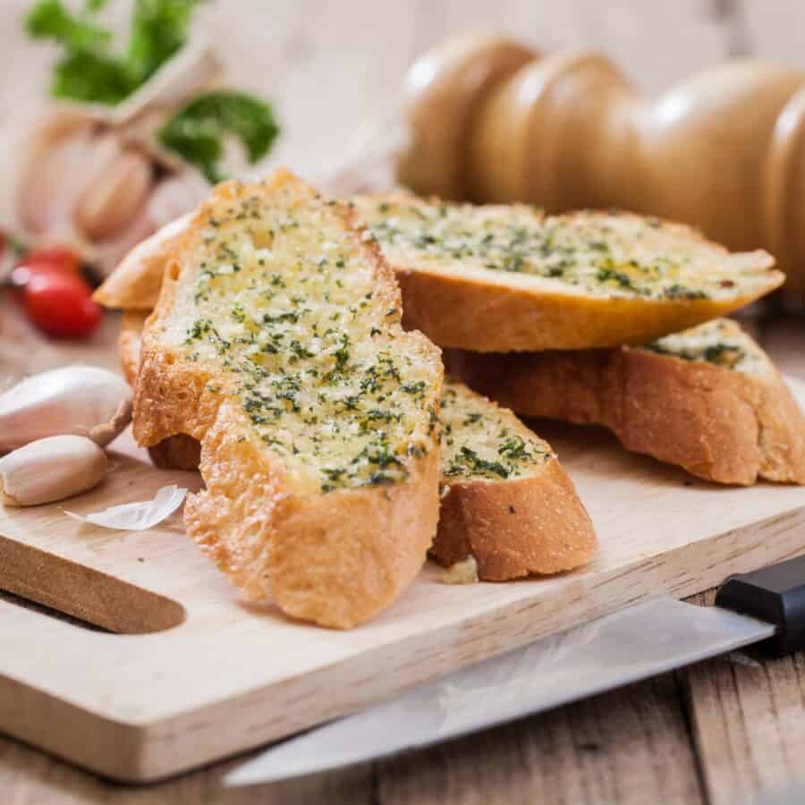 Slices of air fryer garlic bread on a cutting board