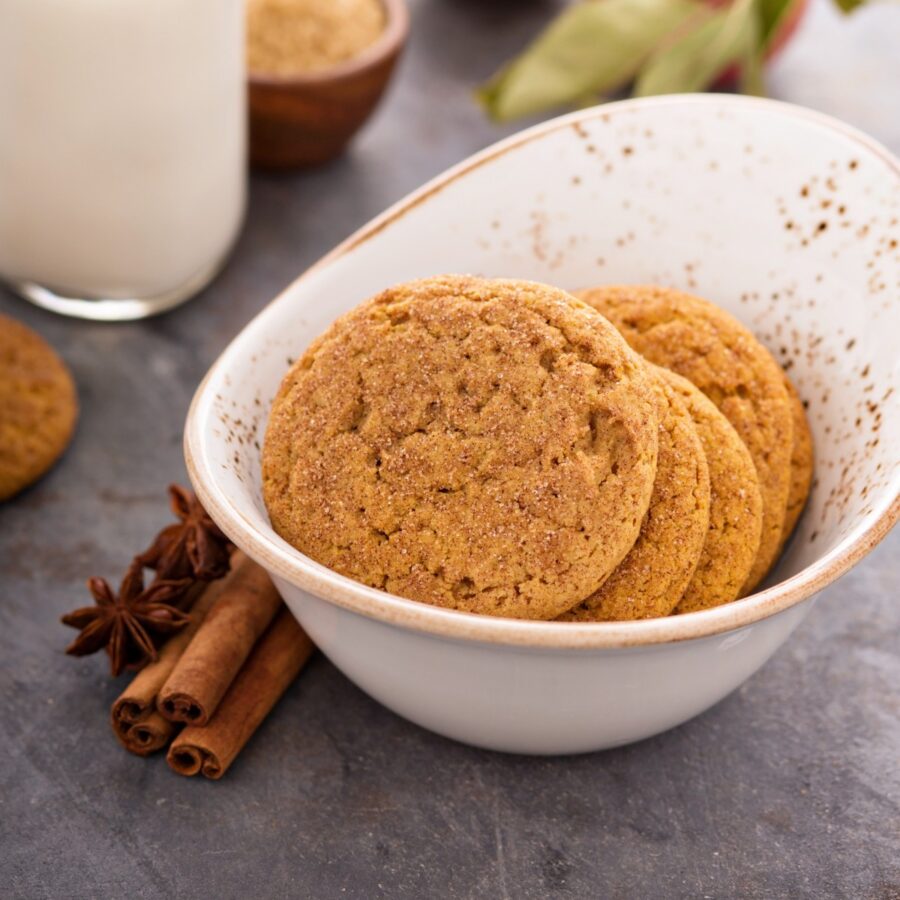 A stack of applesauce cookies in a white bowl