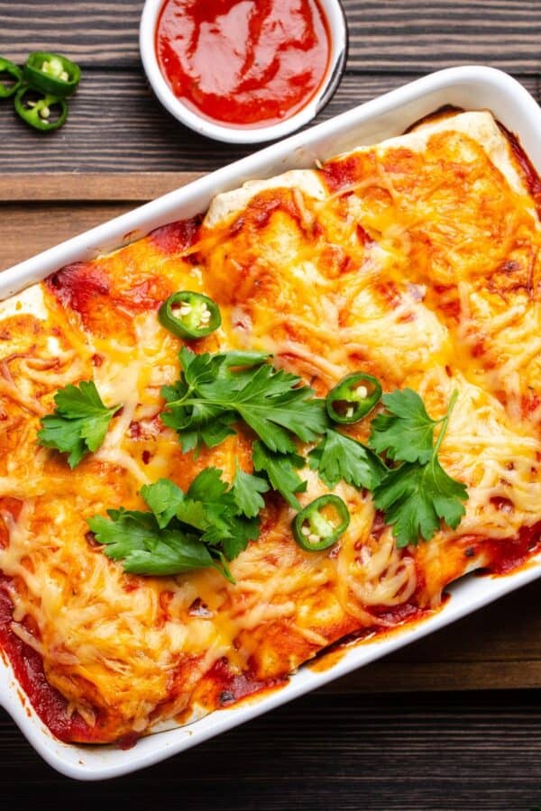 Overhead image of Beef and Been Enchiladas in a white baking dish