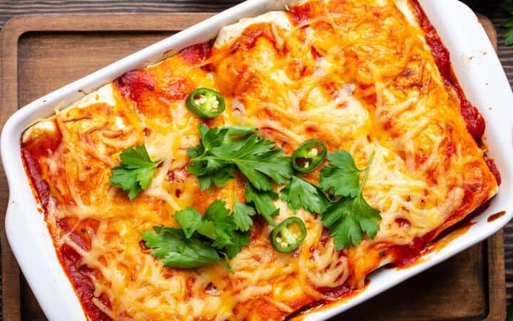 Overhead image of Beef and Been Enchiladas in a white baking dish