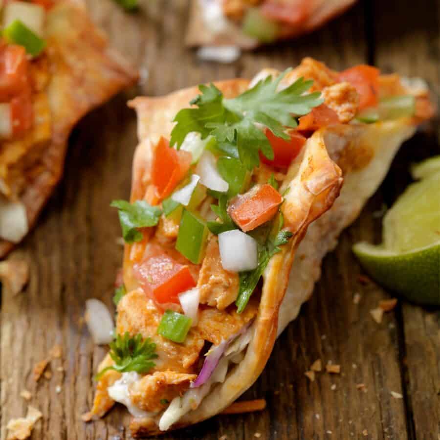 Close up image of Chicken Wonton Tacos on a wooden table