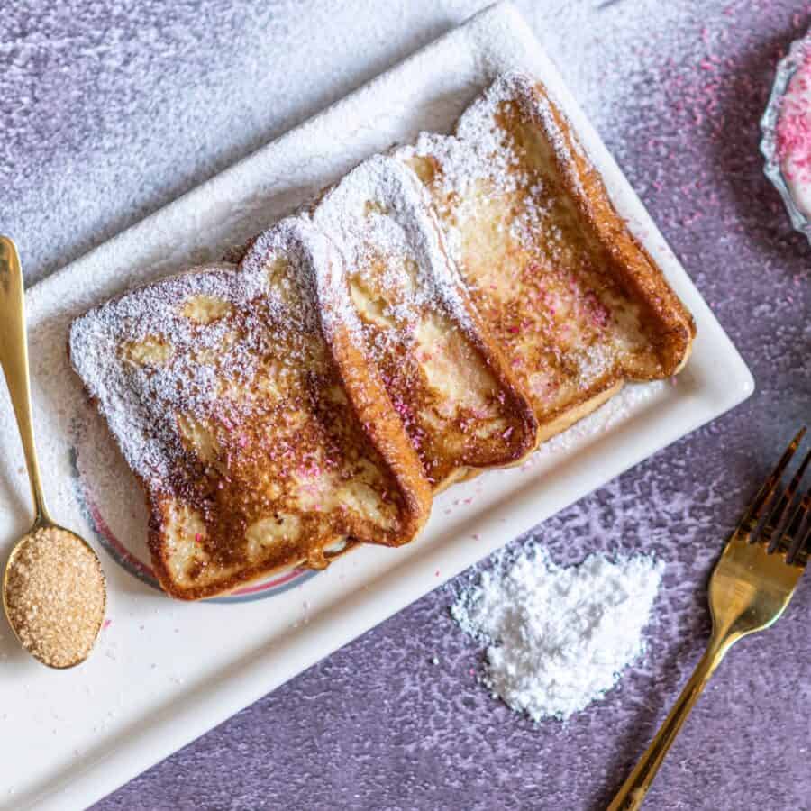 Overhead image of cinnamon french toast on a white plate