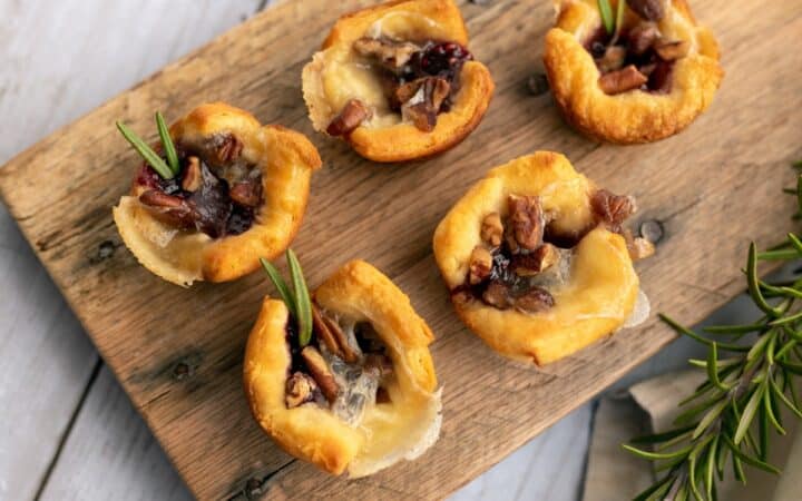 Overhead image of Cranberry Brie Bites on a wooden cutting board