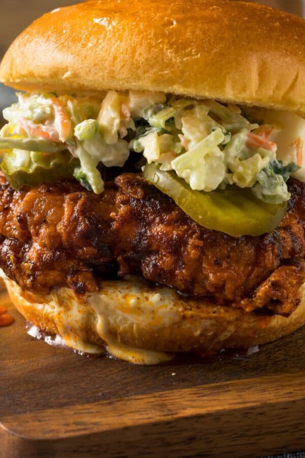 close up image of a Nashville Hot Chicken Sandwich on a wooden cutting board