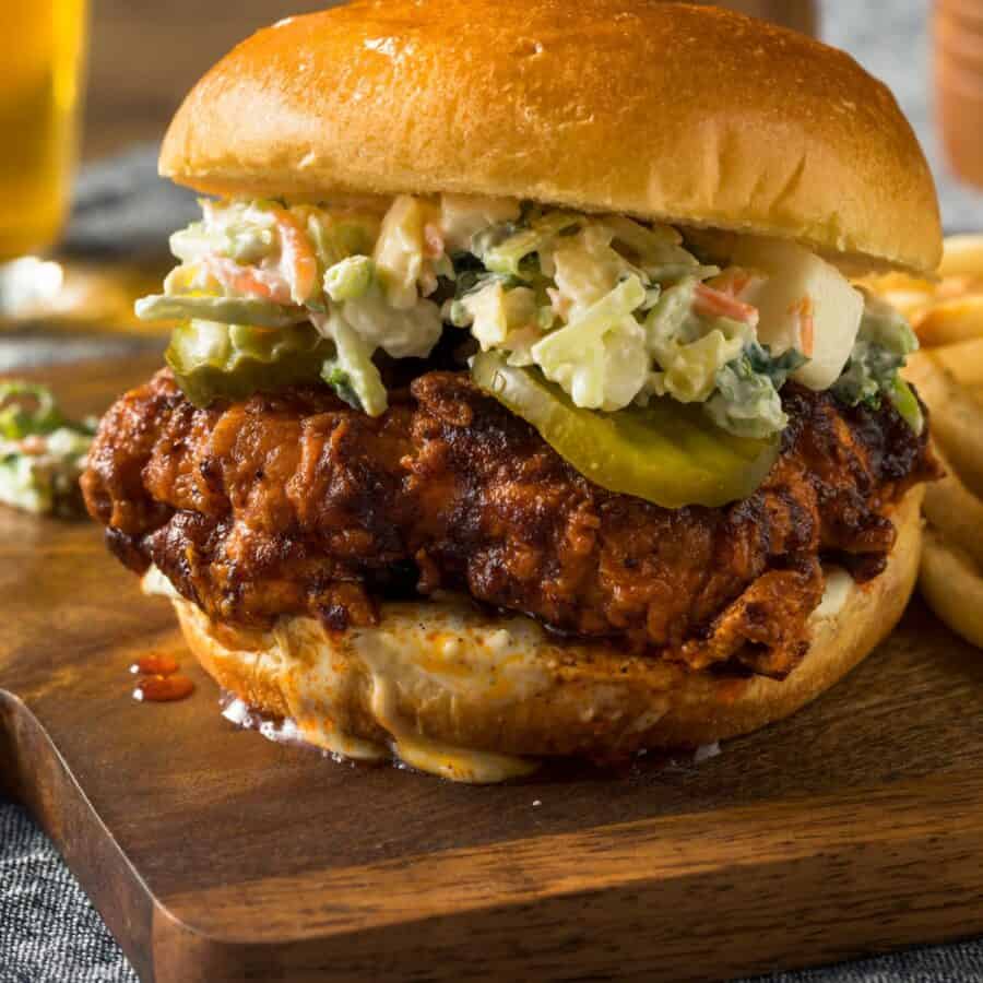 close up image of a Nashville Hot Chicken Sandwich on a wooden cutting board