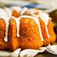 Close up image of a Pumpkin Bundt Cake with glaze drizzle
