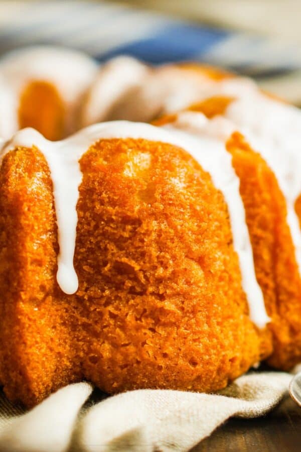 Close up image of a Pumpkin Bundt Cake with glaze drizzle