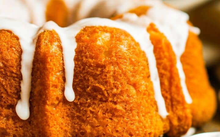 Close up image of a Pumpkin Bundt Cake with glaze drizzle