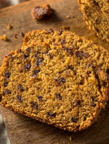 Sliced Pumpkin Chocolate Chip Bread on a wooden cutting board