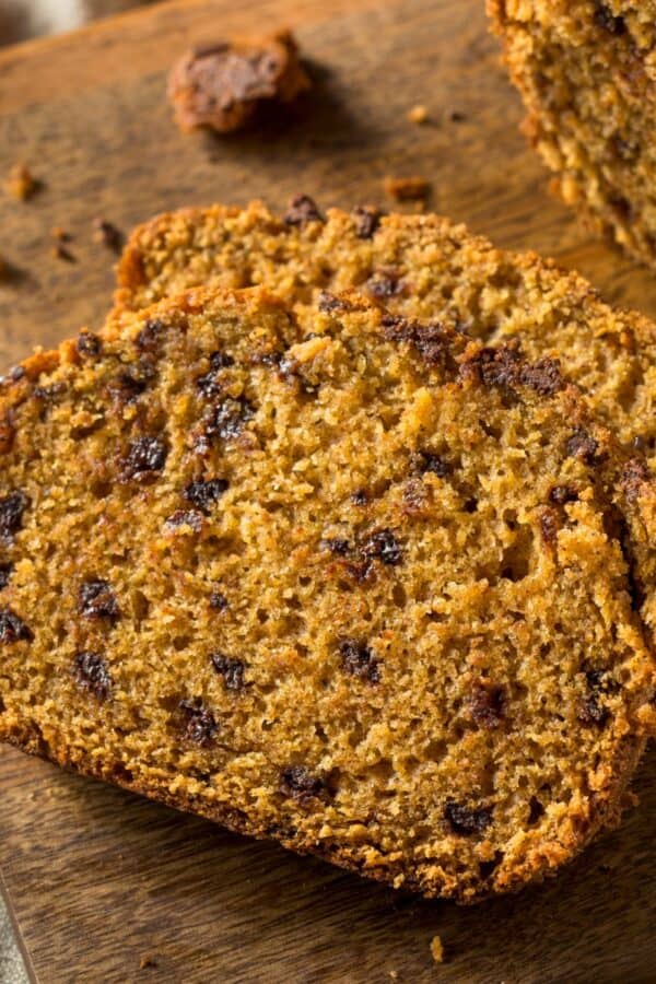 Sliced Pumpkin Chocolate Chip Bread on a wooden cutting board