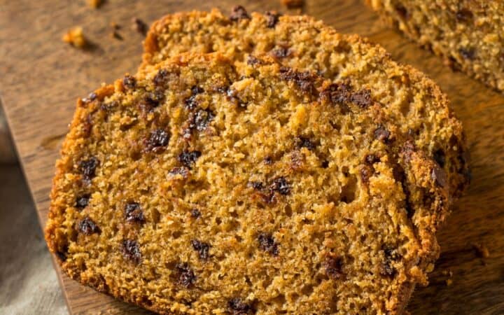 Sliced Pumpkin Chocolate Chip Bread on a wooden cutting board