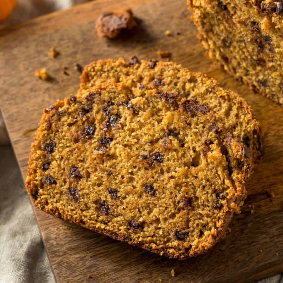 Sliced Pumpkin Chocolate Chip Bread on a wooden cutting board