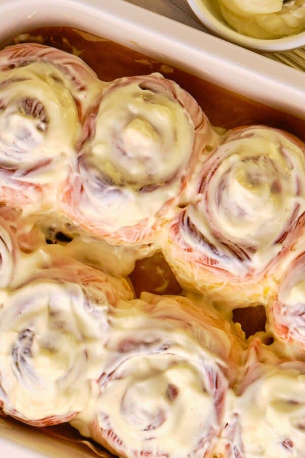 Overhead image of pumpkin cinnamon rolls in a baking dish