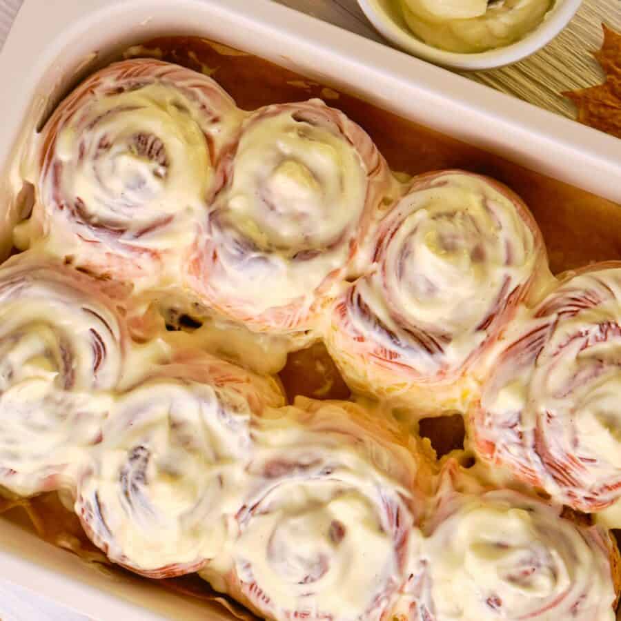 Overhead image of pumpkin cinnamon rolls in a baking dish