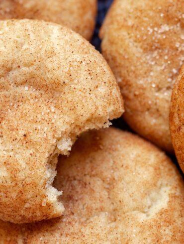 Close up image of Pumpkin Snicker Doodle Cookies. One has a bite taken out of it.