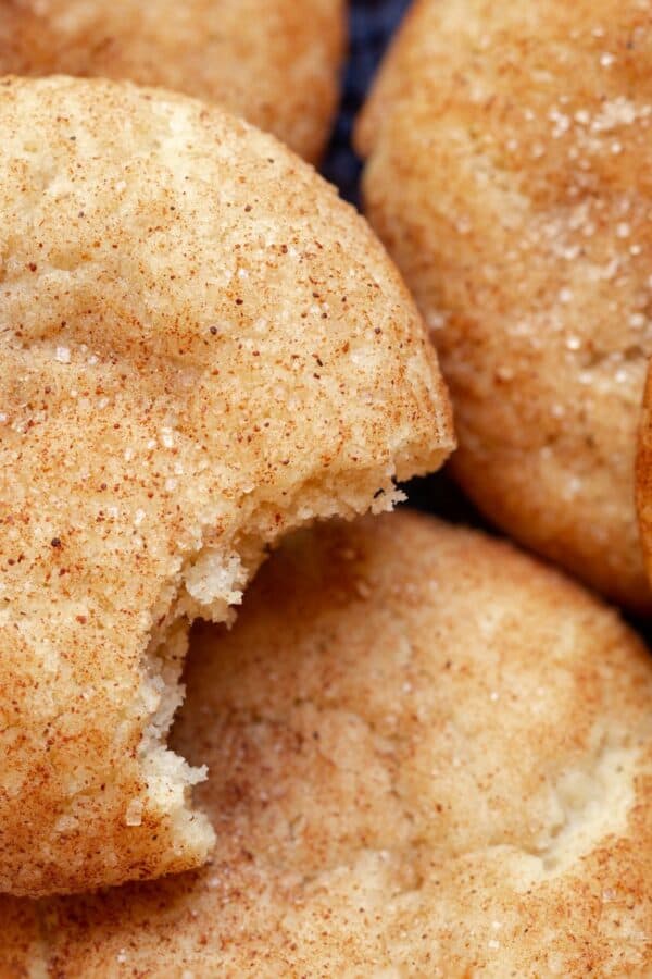 Close up image of Pumpkin Snicker Doodle Cookies. One has a bite taken out of it.