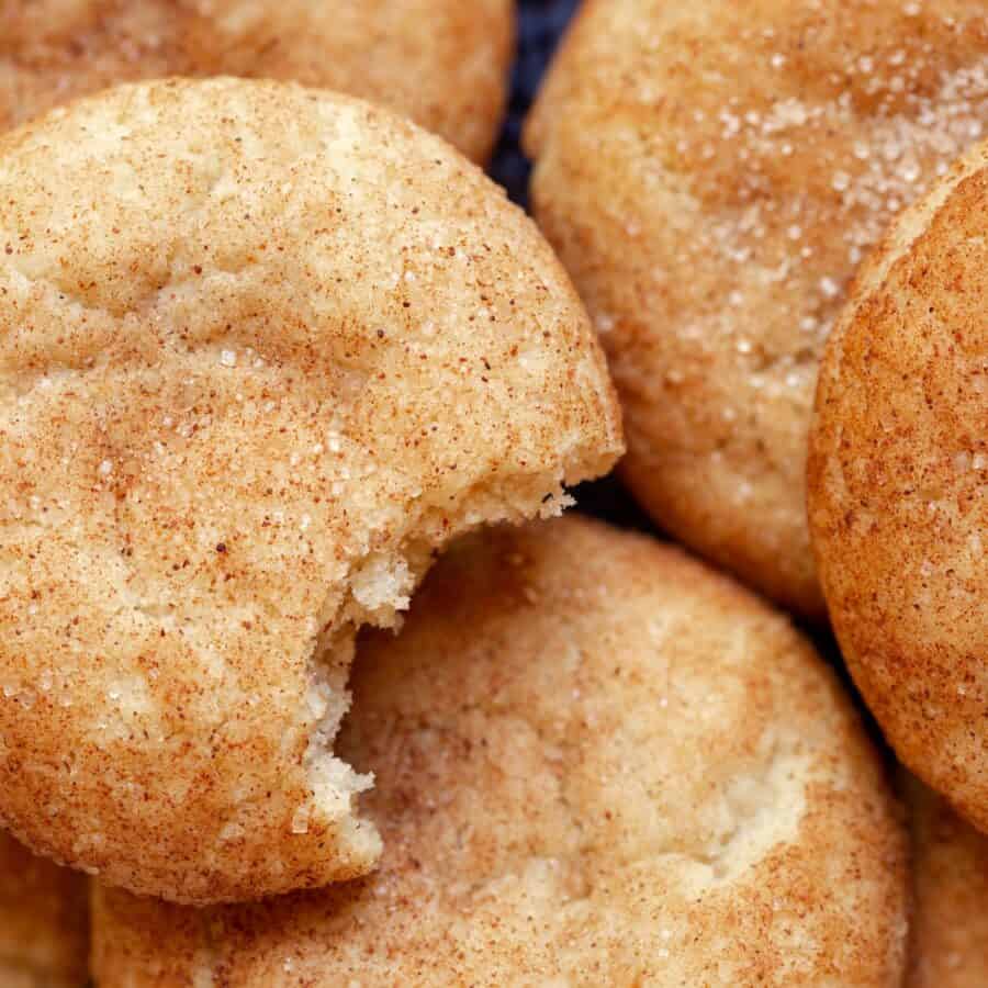 Close up image of Pumpkin Snicker Doodle Cookies. One has a bite taken out of it.