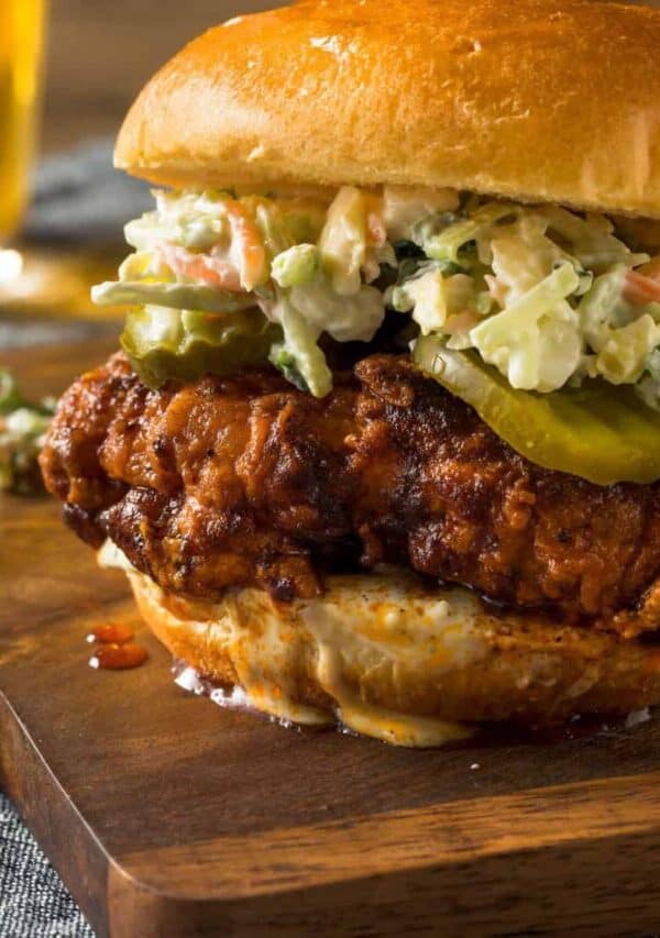 close up image of a Nashville Hot Chicken Sandwich on a wooden cutting board