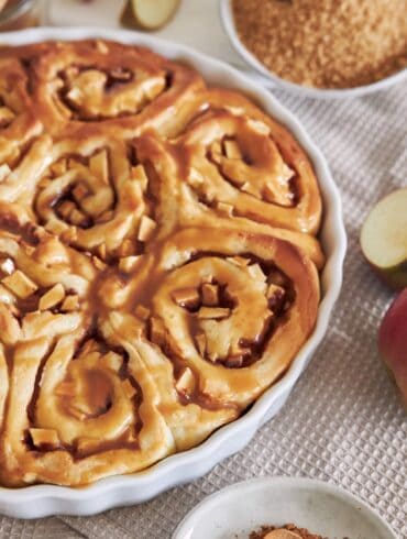 Close up image of Apple Cinnamon Rolls in a white baking dish