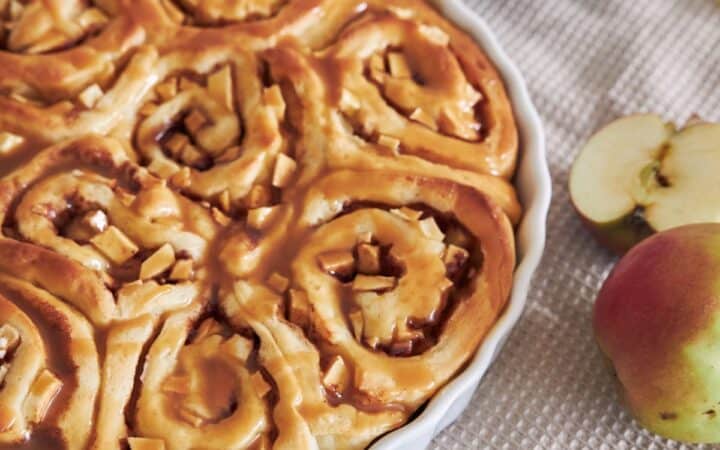 Close up image of Apple Cinnamon Rolls in a white baking dish