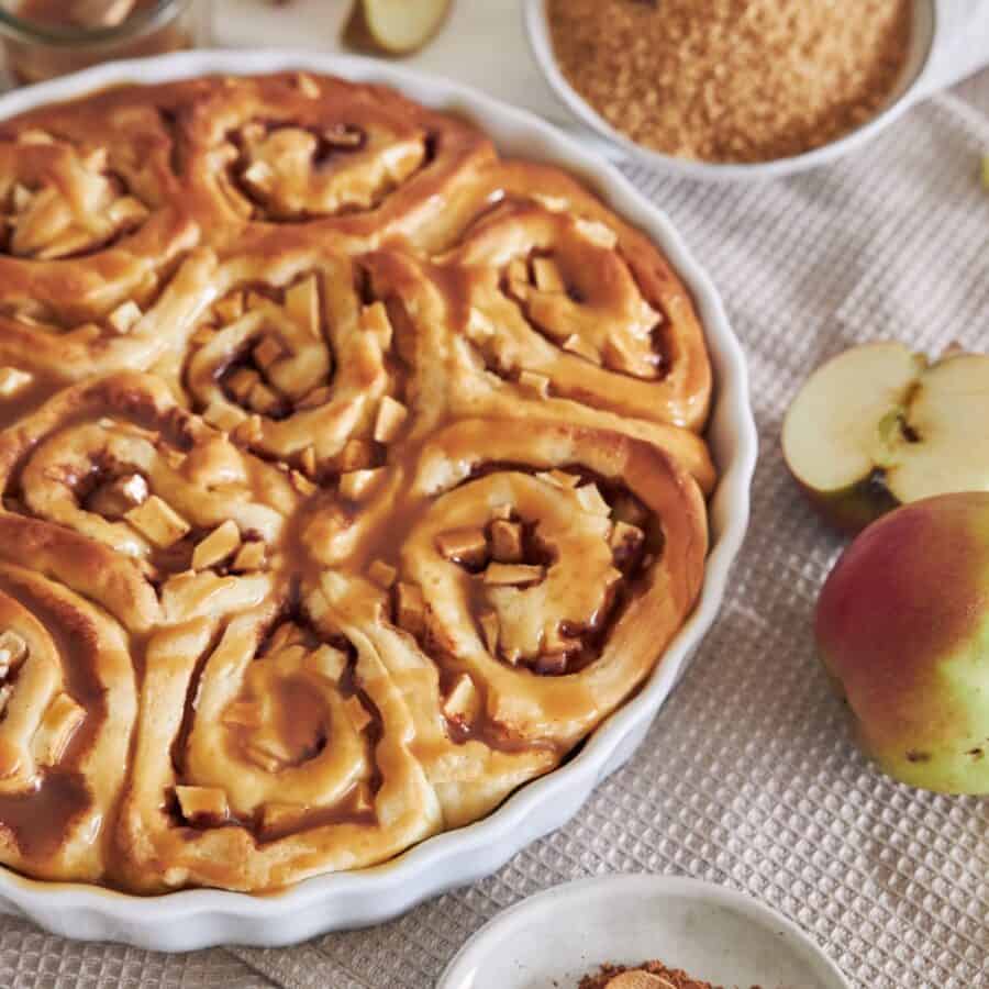 Close up image of Apple Cinnamon Rolls in a white baking dish