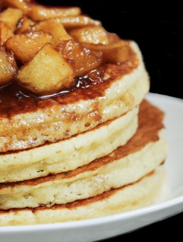 A stack of apple pie pancakes on a plate