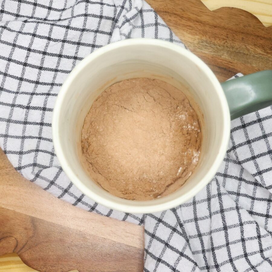 Dry ingredients for a brownie mug cake in a coffee mug