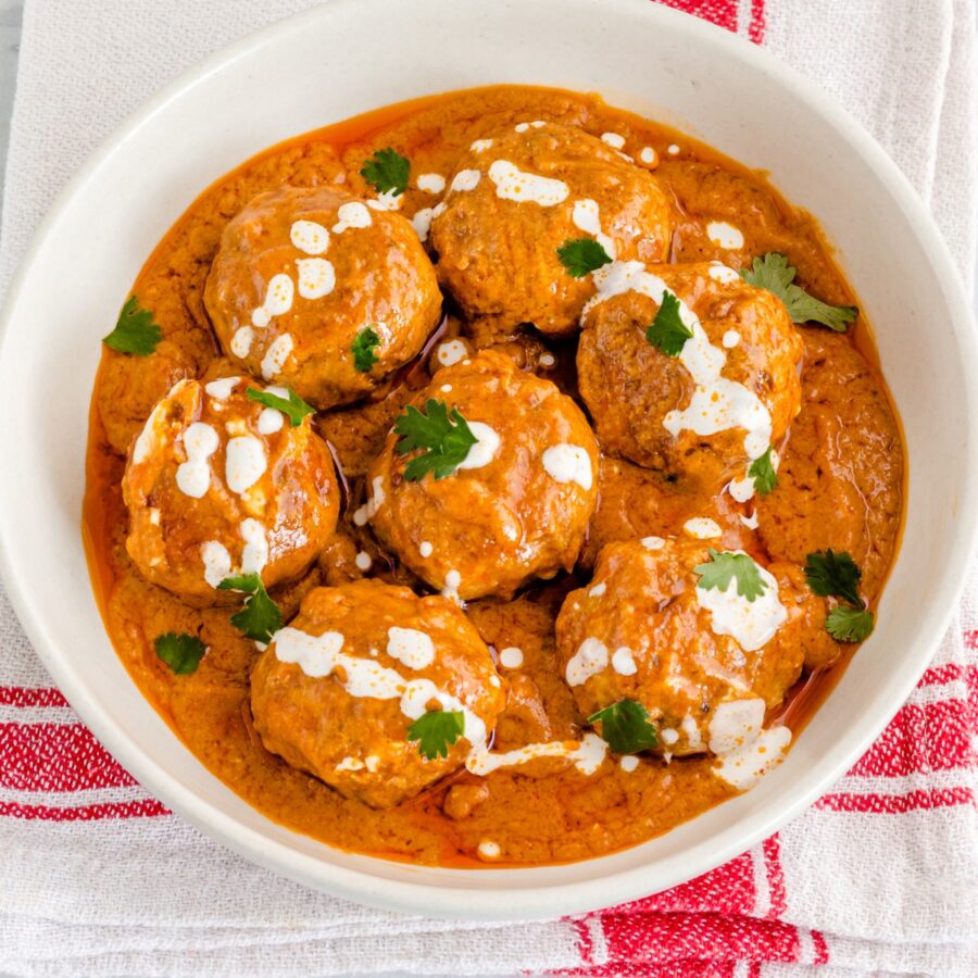 Close up image of Butter Chicken Meatballs in a white bowl