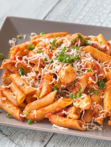 Close up image of Chicken Penne Pasta on a square plate